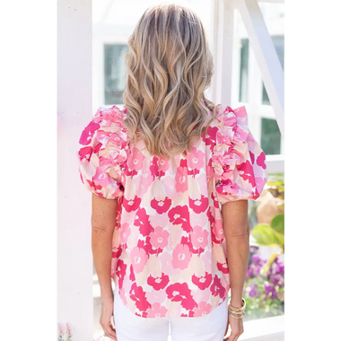 Pink and white floral puff-sleeve blouse with wavy blonde hair, perfect for all sizes