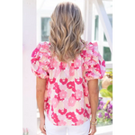 Pink and white floral puff-sleeve blouse with wavy blonde hair, perfect for all sizes