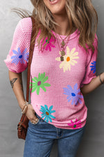 Pink waffle-knit sweater with colorful floral designs perfect for relax relax styles