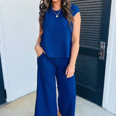 Woman in a blue ribbed knit pantsuit from Sky Blue Textured Knit Cap Sleeve Set