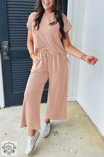 Woman in a peach-colored ribbed knit lounge set, ideal for relaxing in style