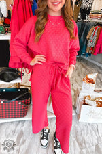 Woman in a pink lounge set from Strawberry Pink Checkered Textured collection in UK sizes