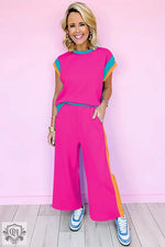 Woman in a bright pink pantsuit showcasing casual two-piece set with relaxed fit