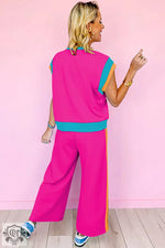 Bright pink two-piece pantsuit featuring color block detail for a relaxed fit