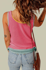 Pink knitted sleeveless top with yellow trim styled with light-wash denim for relax relax