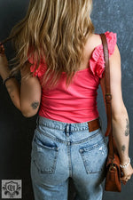 Woman wearing Strawberry Pink Ruffled Wide Straps Slim Tank Top paired with jeans