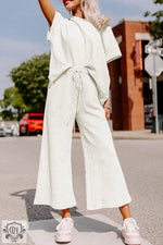 Woman in a white lounge set from the Strawberry Pink Textured Loose Fit collection