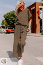 Woman in brown knitwear showcasing the Strawberry Pink Loose Fit T Shirt and Pants Set