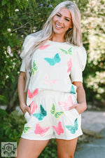 White romper with pink and turquoise butterfly print, perfect for sizes bust hem