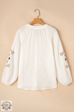 White long-sleeved blouse with embroidered spirals, available in Euro sizes