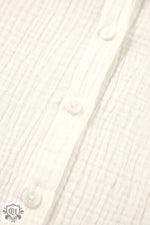 White wooden planks with visible screws complement White Embroidered Textured Buttoned Shirt