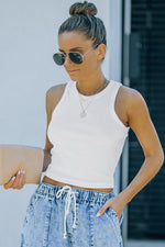 White sleeveless crop top with high-waisted denim jeans showcasing bust shoulder length fit