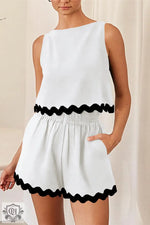 White sleeveless romper with black scalloped trim for stylish summer relax relax