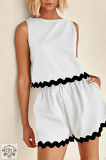 White sleeveless romper with black rickrack trim for the Relax Relax collection