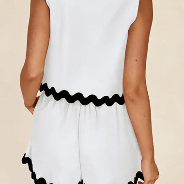 White sleeveless romper with black wavy trim in sizes for a stylish relax relax look