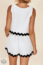 White sleeveless romper with black wavy trim in sizes for a stylish relax relax look