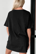 Black oversized t-shirt dress showing short sleeves and relaxed fit for all sizes