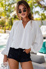 White Solid Color V Neck Balloon Sleeve Shirt with black denim shorts for a relaxed look