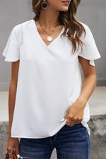 White V-neck blouse with flutter sleeves and blue jeans in sizes bust waist relax relax