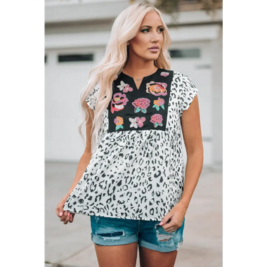 Floral embroidered leopard print blouse with distressed denim shorts, perfect for relaxed wear