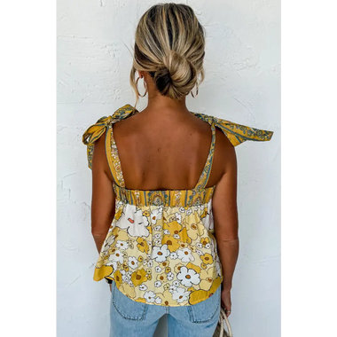 Floral yellow and white sleeveless top with tied straps and gathered waist in various sizes